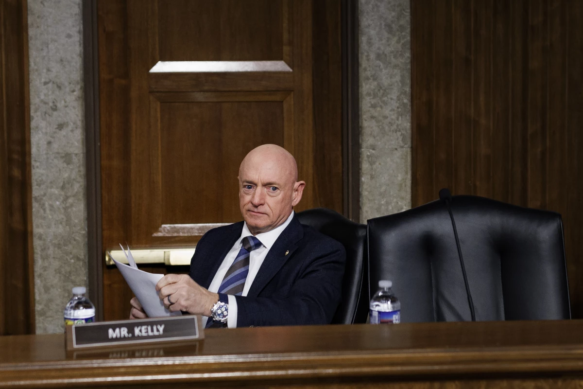 Sen. Mark Kelly, D-Ariz., takes his seat during a Senate Armed Services Committee hearing on January 15.