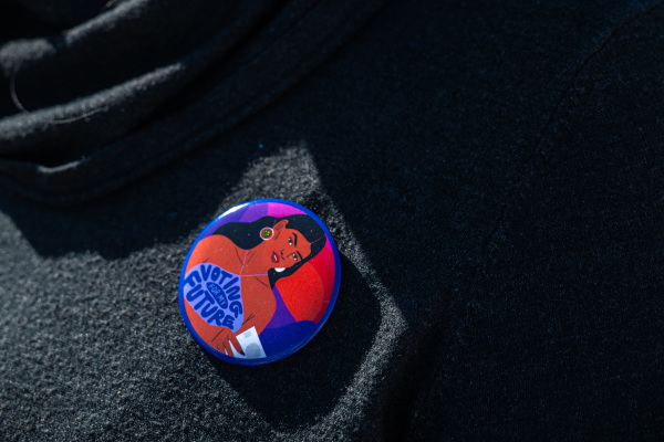 A woman wears a pin that reads "Voting for my Future" at the Gallup Flea Market in Gallup, N.M., on Oct. 12, 2024.