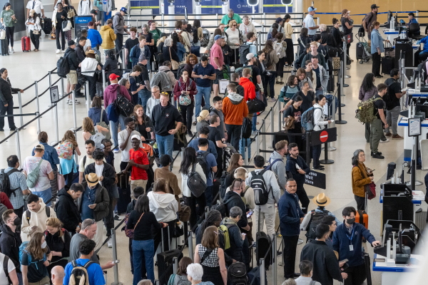 Travelers go through security at San Francisco International Airport.