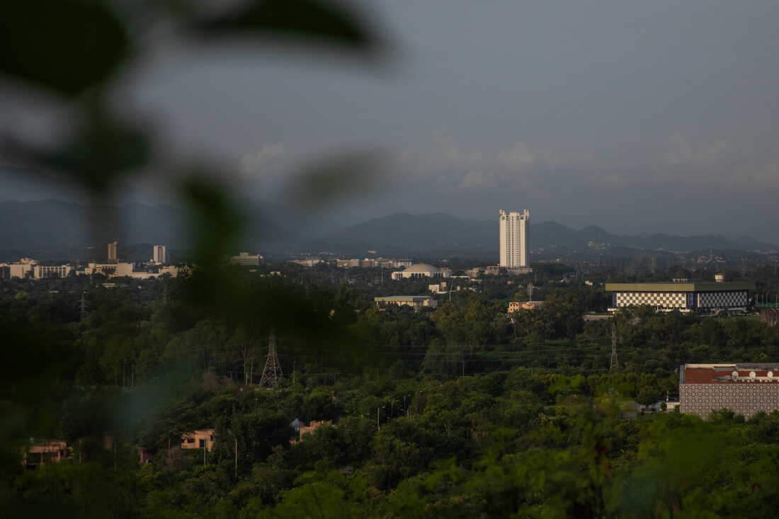 One Constitution Avenue., a luxury highrise, is seen from a lookout point on August 20, 2026 in Islamabad, Pakistan. Residents of areas near Bari Imam contrast how they were treated to residents of contrasted how they were treated, and spoken of, to residents of the apartment complex, which was built without proper authorization.