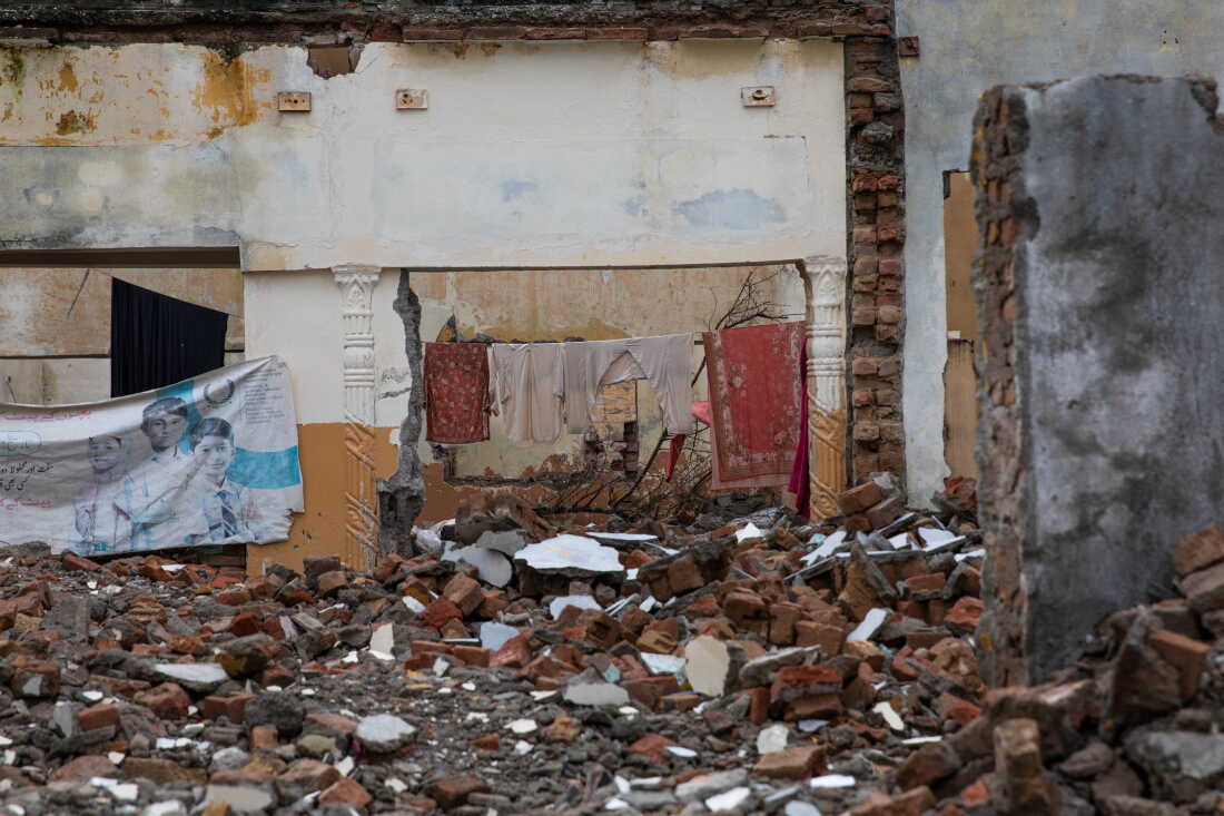 Clothing is seen drying inside a demolished building near Bari Imam on August 20, 2026 in Islamabad, Pakistan.