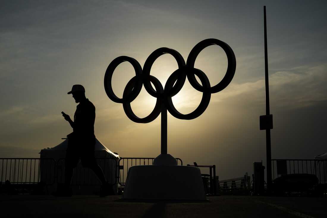 The sun sets behind the Olympic rings at the Olympic marina during the 2024 Summer Olympics, Friday, Aug. 2, 2024, in Marseille, France.