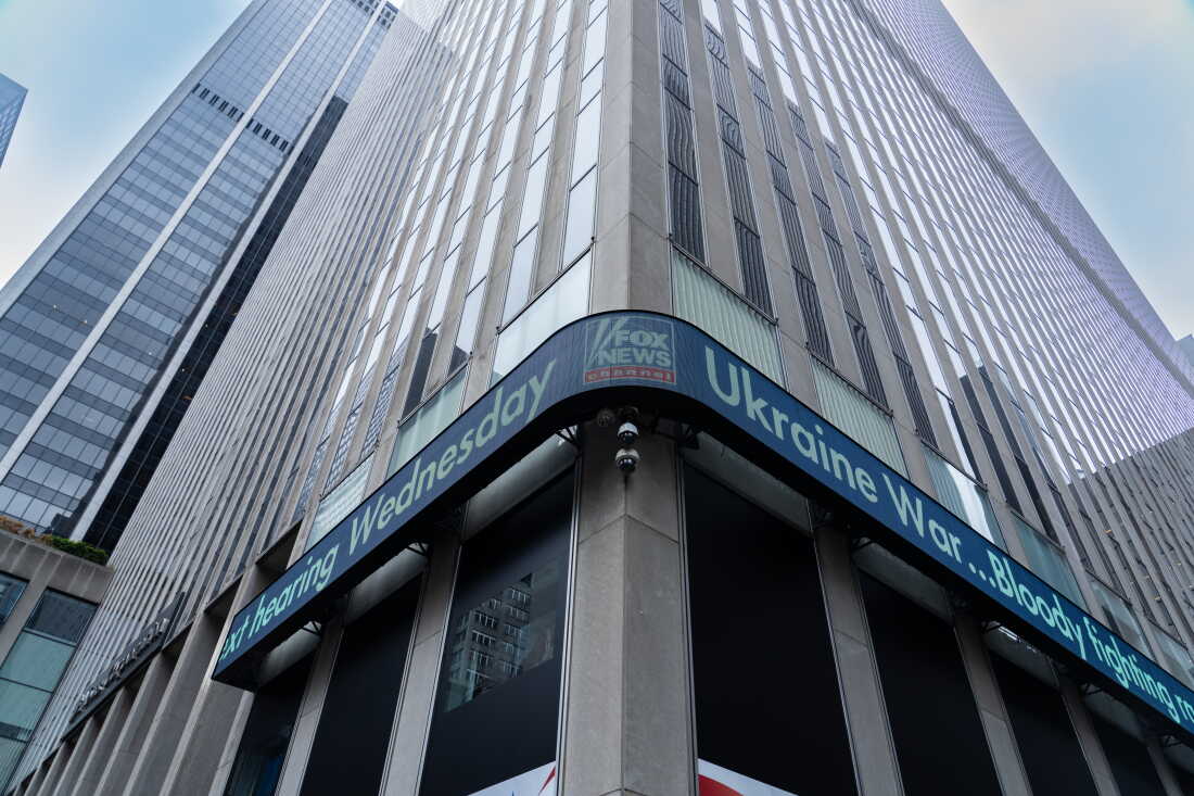 A news ticker that wraps around two sides of the Fox News headquarters building in New York City displays headlines, including one about the Ukraine war, in April 2023.
