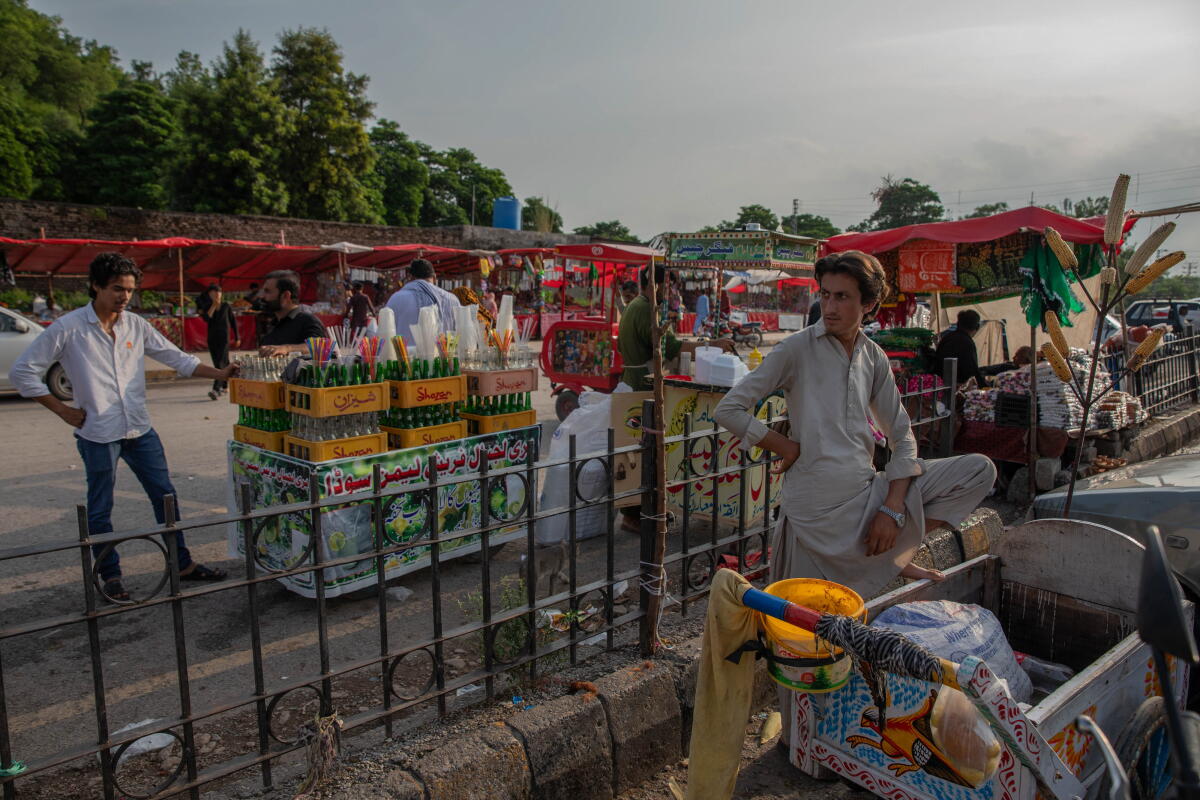 Vendors sell food and drinks outside the Bari Imam shrine. Businesses around the shrine were destroyed along with homes during a demolition drive last winter and spring.