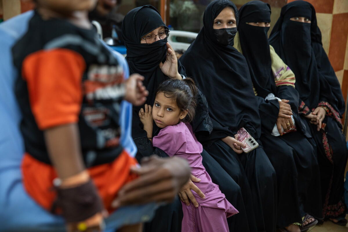 Parents and children wait for care at Kulsum Bai Valika Hospital on July 25 in Karachi, Pakistan. Families say their children tested positive for HIV after syringes were used on multiple children being treated for other illnesses.