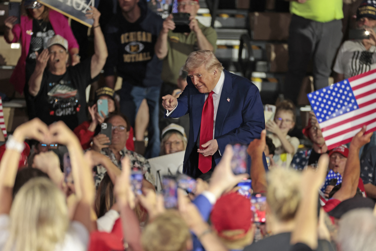 Trump gestures to the crowd at the at the end of his address marking 100 days in office.