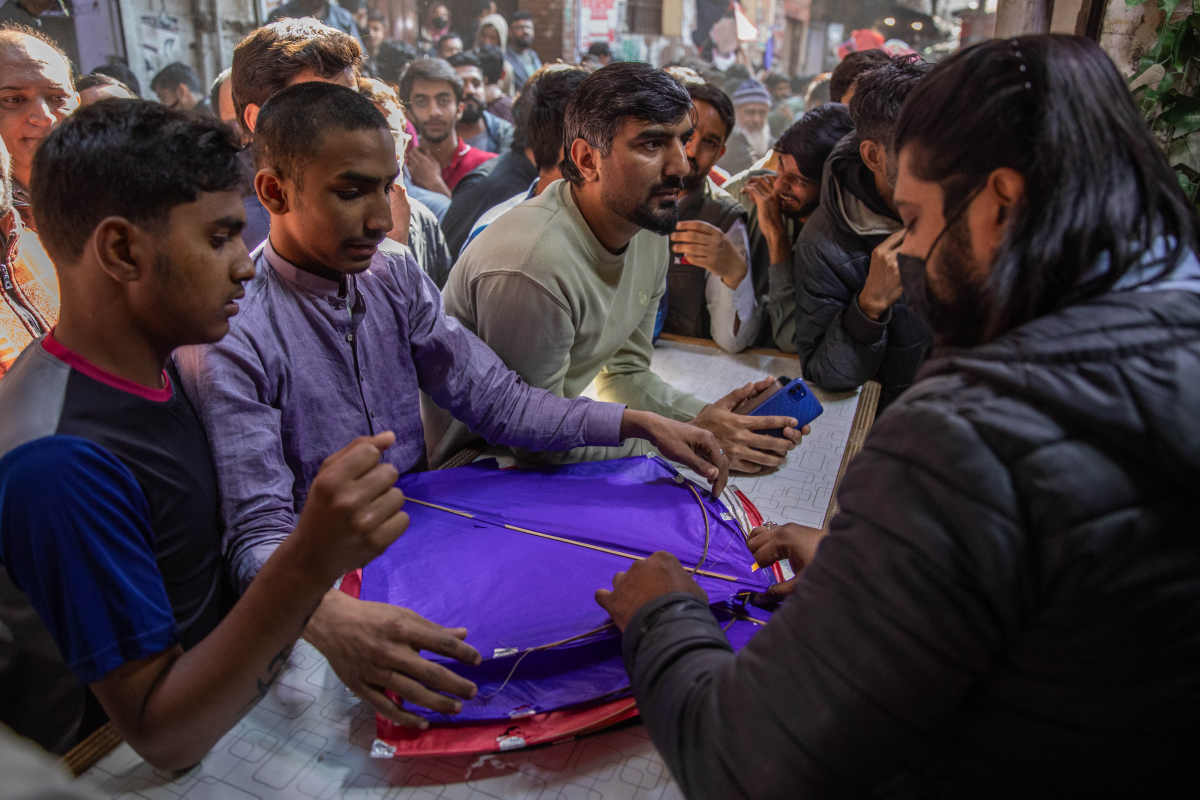 Men shop for kites in a market area near Mochi Gate.