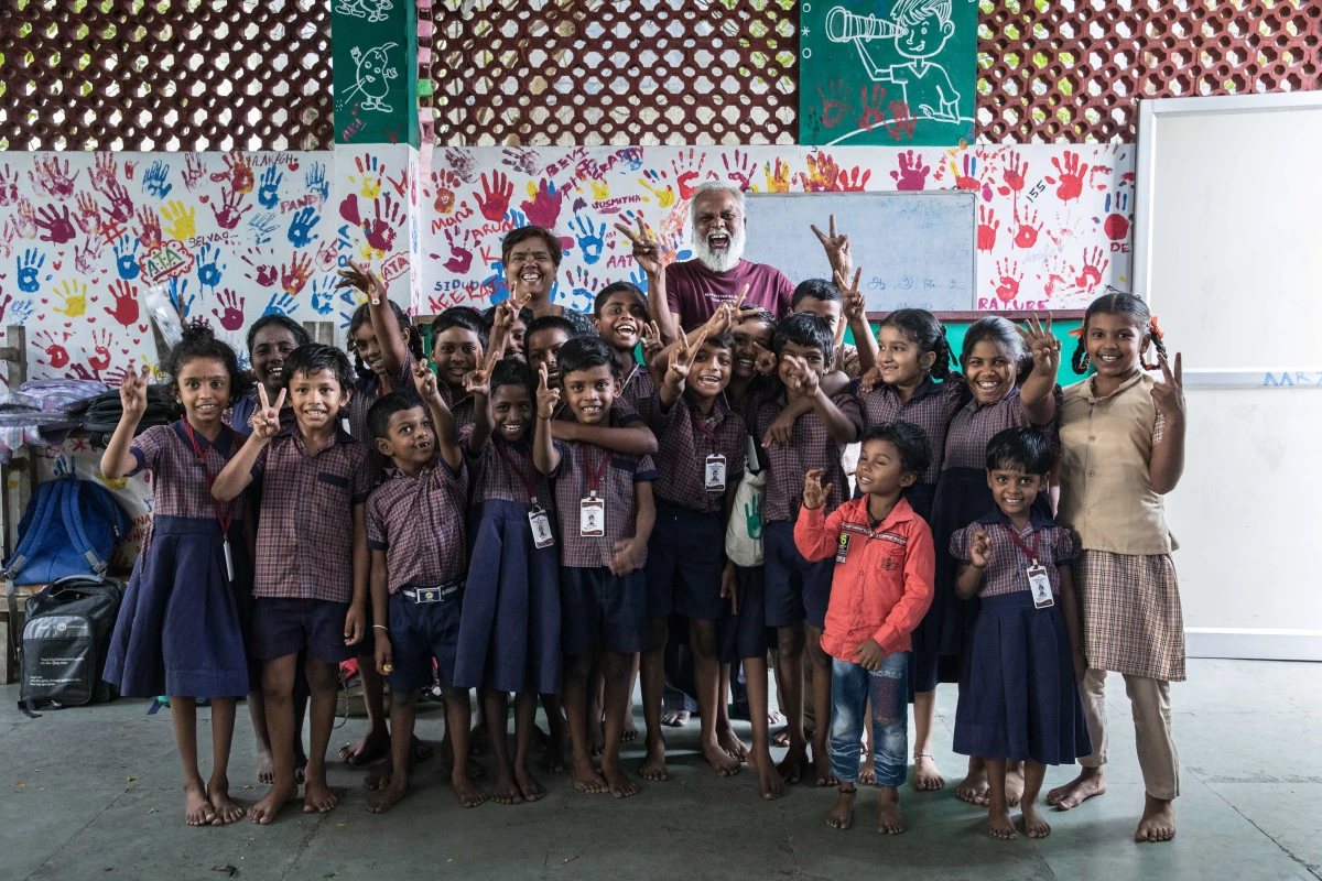 A group photograph of Mo Pandiarajan with his students in the classroom of Eden School, Muthupetty, rural Tamil Nadu. He built the private school in his parents' home and offers classes to kids who are often first-generation learners.