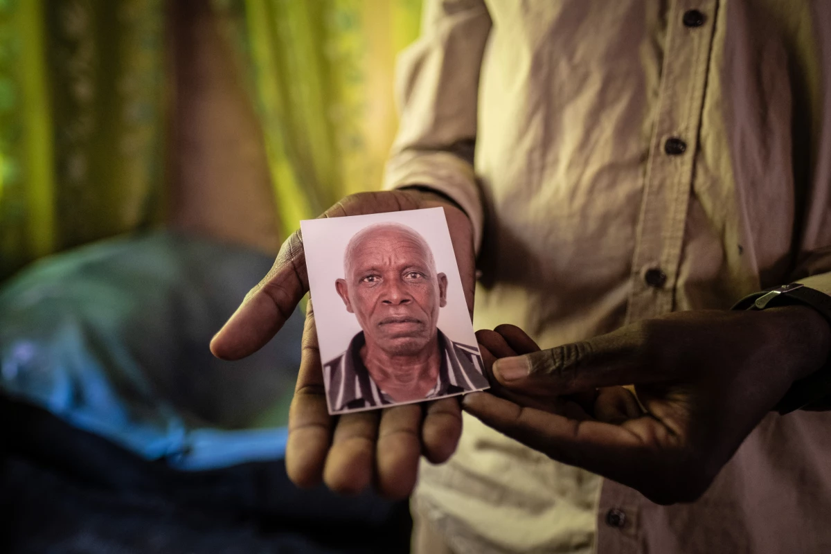 Luka Chiyesu, 39, displays a photo of his father, Luka Makongo Chiyesu, 91, who was killed by an elephant in Livingstone, Zambia, in August 2024.