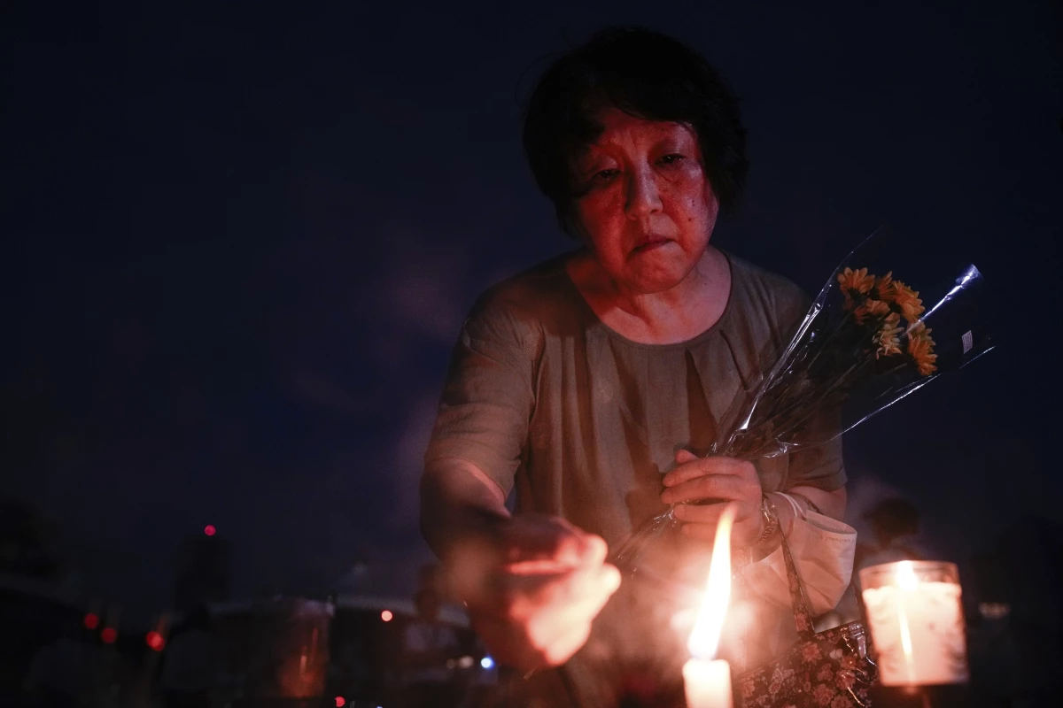 A visitor lights incense sticks at the Peace Memorial Park ahead of the memorial service to mark the 80th anniversary of the WWII U.S. atomic bombing in Hiroshima, Wednesday, Aug. 6, 2025, in Japan.