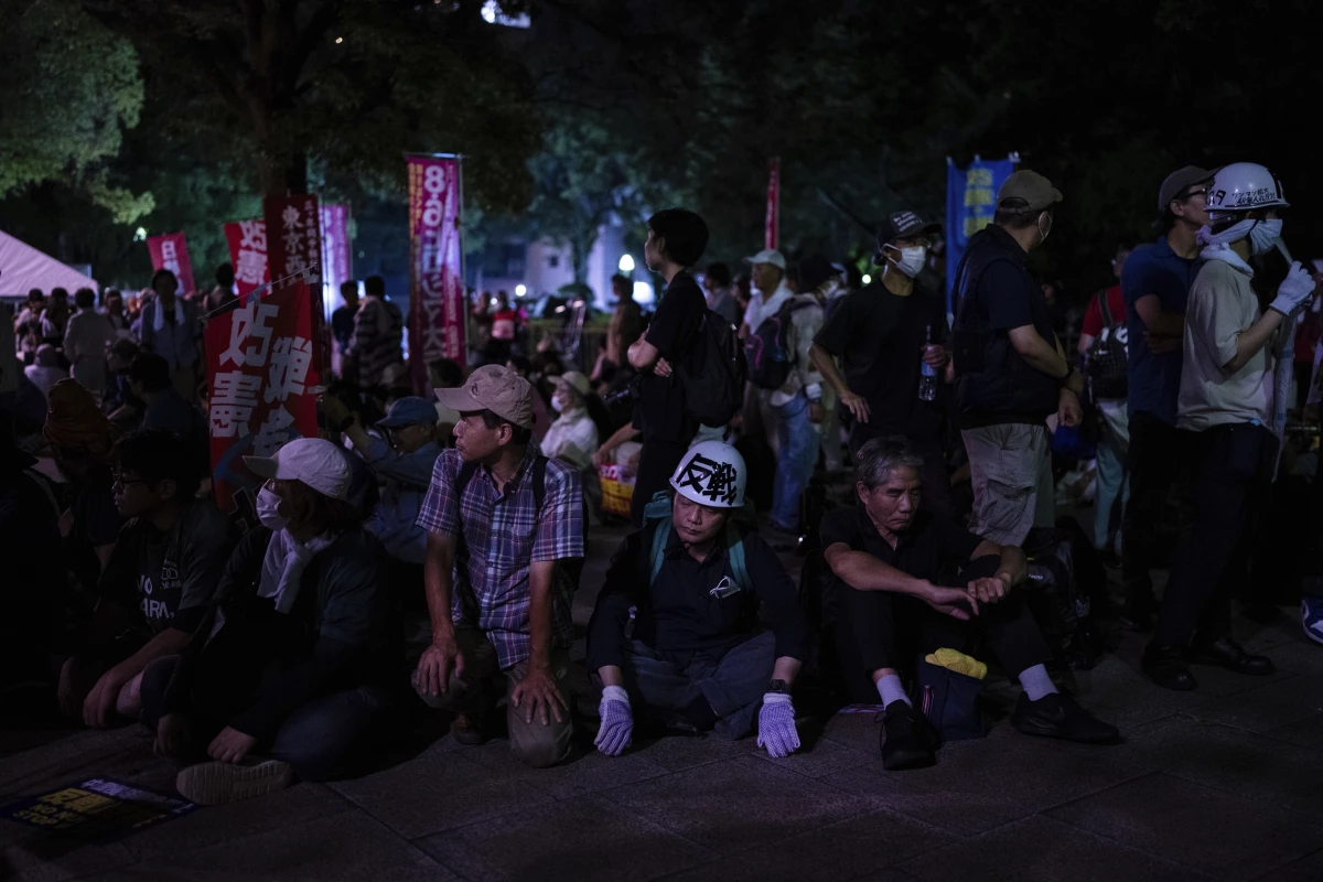 Protesters sit outside the Atomic Bomb Dome ahead of the memorial service to mark the 80th anniversary of the WWII U.S. atomic bombing in Hiroshima on Aug. 6, 2025, in Japan.