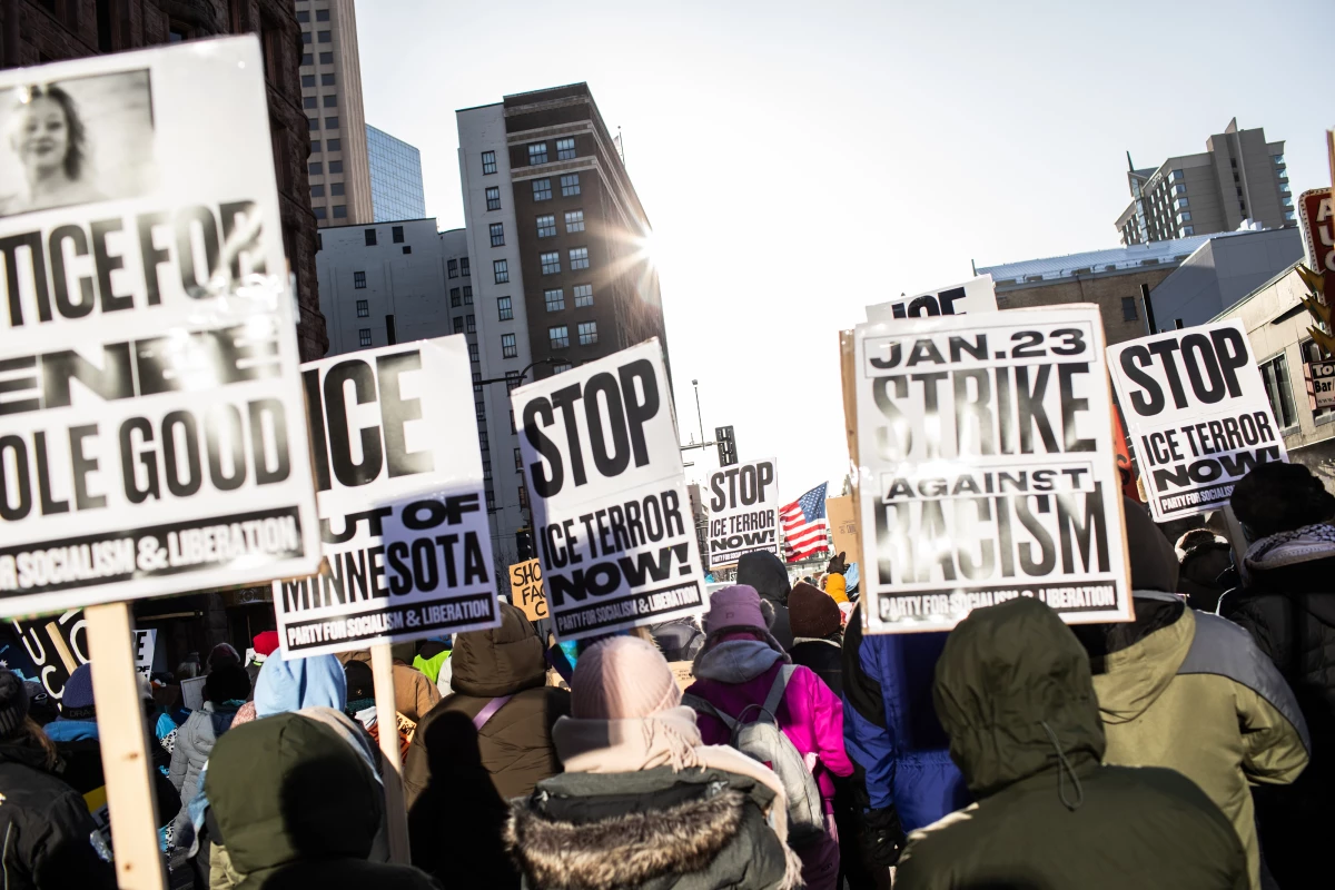 Protesters hold signs demanding justice for Renee Good, who was killed by an ICE agent, and calling to stop ICE operations in Minneapolis, Minn., Jan. 23, 2026.