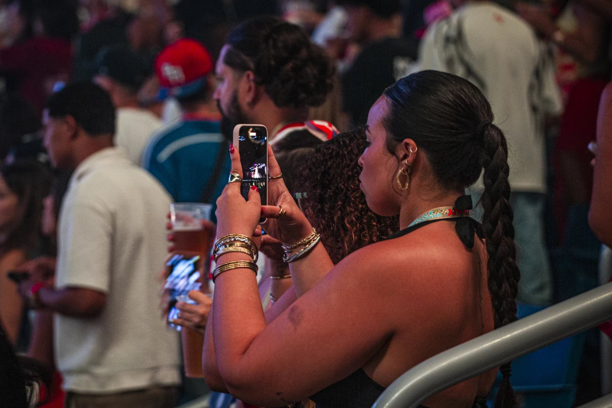 A fan takes a photo.