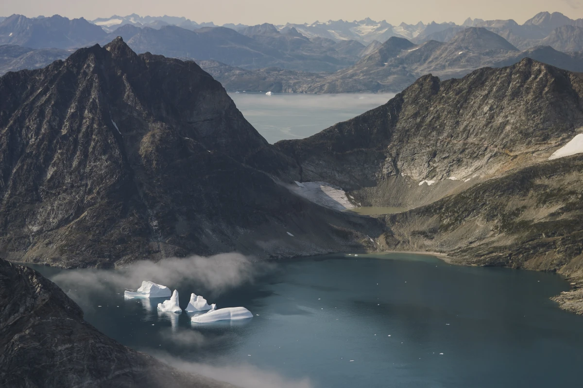 Icebergs are photographed from the window of an airplane carrying NASA scientists as they fly on a mission to track melting ice in eastern Greenland on Aug. 14, 2019.