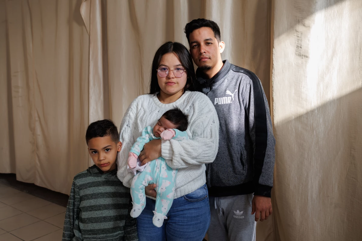 Venezuelans Ricardo Bravo, 29, his wife Bárbara Mendoza, 28, their son Mathias Mendoza, 6, and one-month-old daughter Sáhira Bravo pose for a portrait inside of El Buen Samaritano migrant shelter in Ciudad Juárez, Chihuahua state, Mexico on Sunday, December 8, 2024.