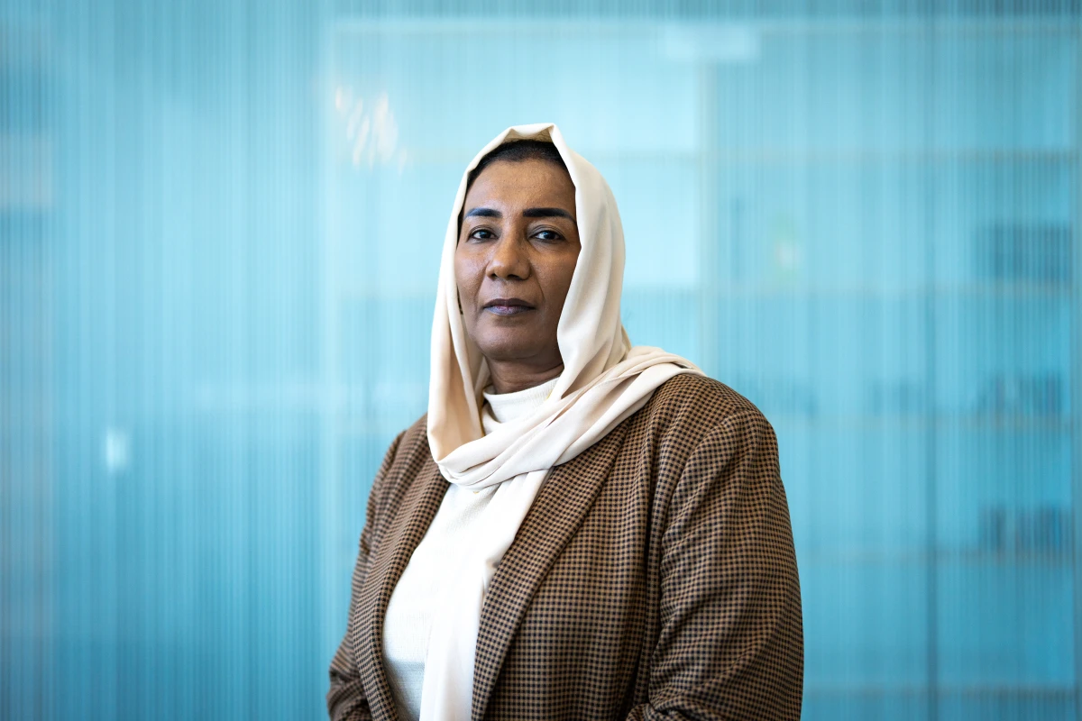 Eatizaz Yousif, the Sudan country director for the International Rescue Committee, poses for a portrait at NPR headquarters in Washington, D.C. on June 24. She herself was displaced by the conflict a year ago. “As Sudanese, we are pretty resilient,' she says, referring to the fighting that has caused 12 million people to flee from their homes. 'But this is beyond our resilience.'