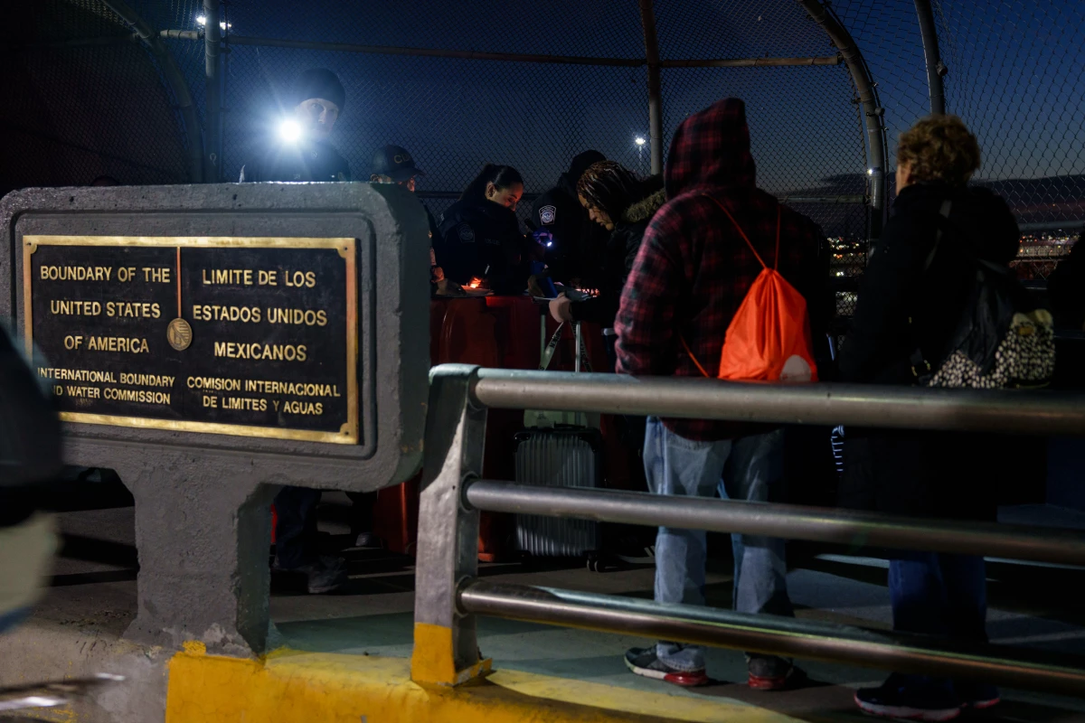 Migrants with CBP One appointments have their paperwork checked by CBP agents atop the Paso del Norte International Bridge before being allowed to cross into the United States, in Ciudad Juárez, Chihuahua state, Mexico on Monday, December 9, 2024.