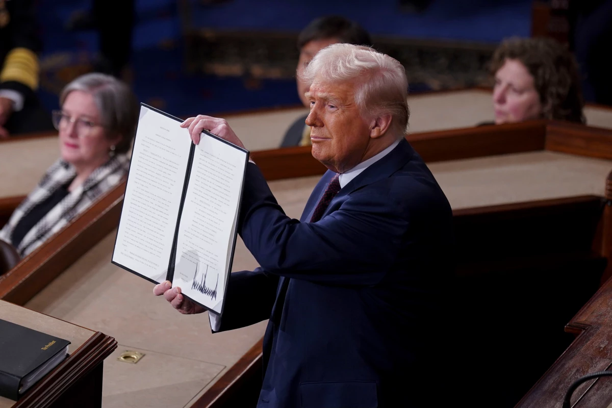 President Trump holds a signed executive order that renames a wildlife sanctuary in honor of late Jocelyn Nungaray during a joint session of Congress in the House Chamber of the US Capitol.