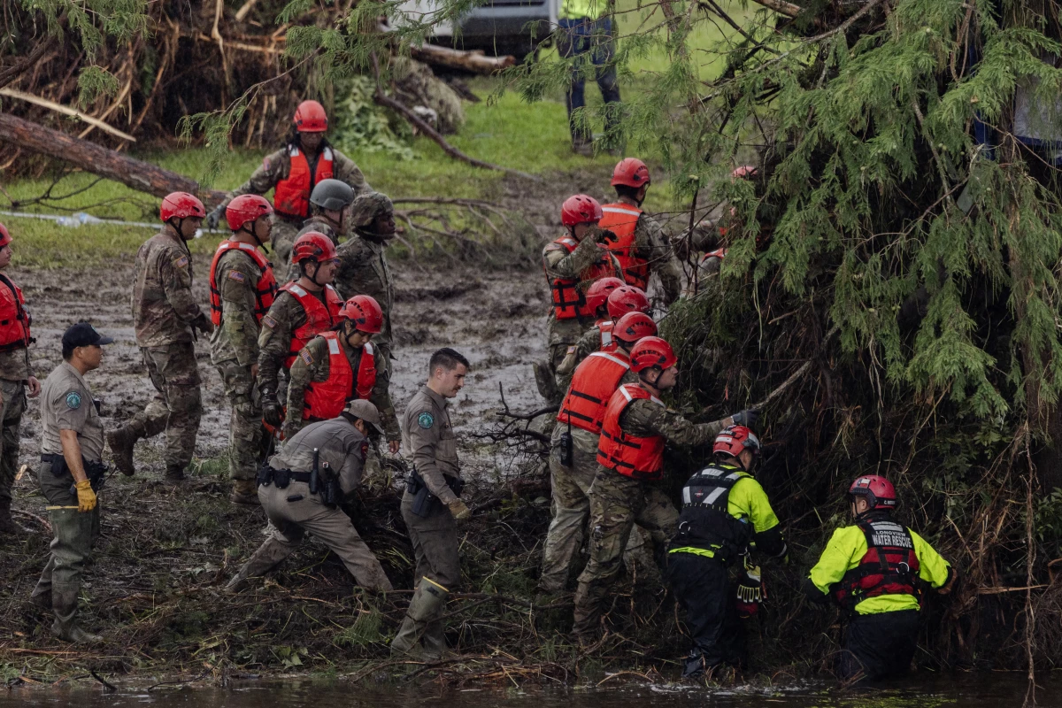 Search and recovery workers dig through debris at Camp Mystic near Hunt, Texas, on Sunday.