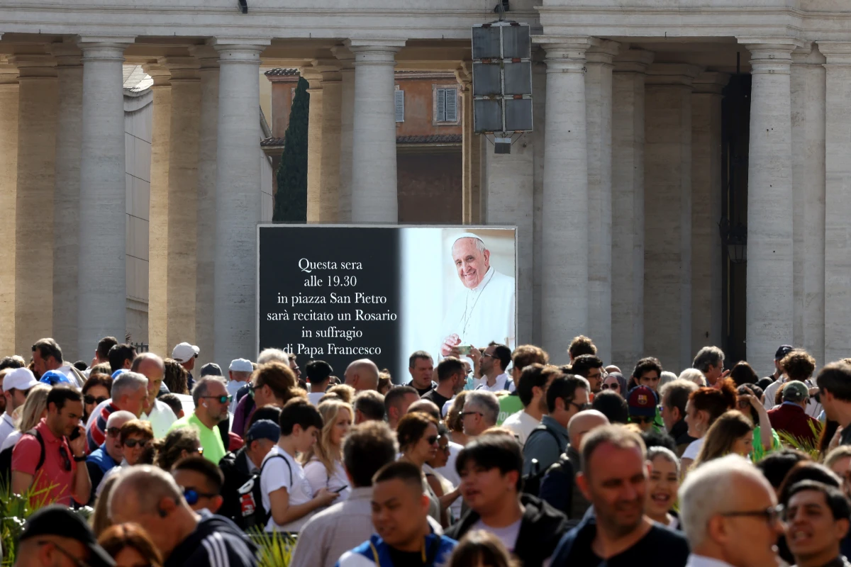 A digital screen shows an image of Pope Francis in Saint Peter's Square on Monday in Vatican City.