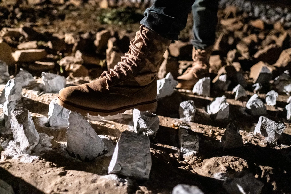 A member of the Elephant Response Team navigates walls of jagged rocks — a form of elephant deterrent currently being tested.