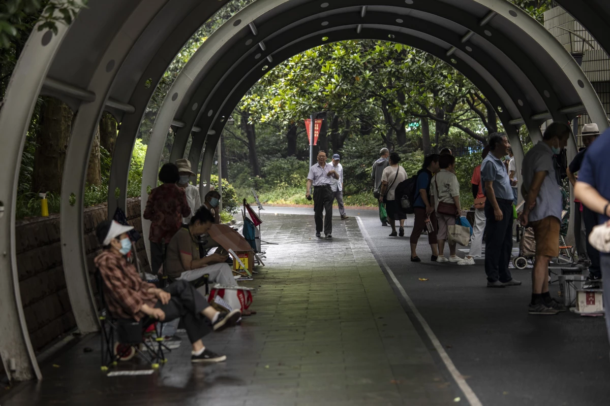 Match makers display personal info of individuals seeking prospective mates at a corner of the People's Park in Shanghai, China, on Sunday, June 25, 2023.