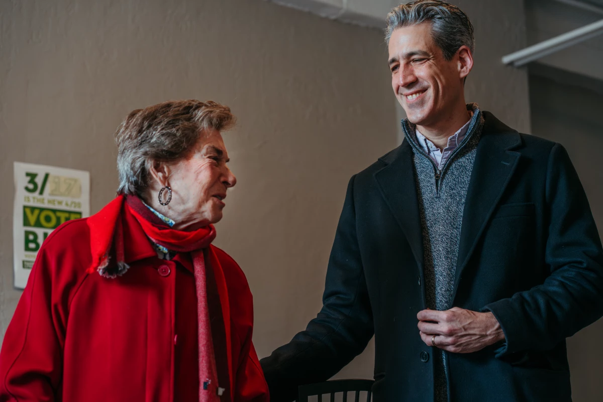 Rep. Jan Schakowsky, D-Ill., stands alongside Evanston Mayor Daniel Biss as he addresses volunteers at his campaign office on February 28, 2026. Schakowsky, who is retiring from Congress, has endorsed Biss.