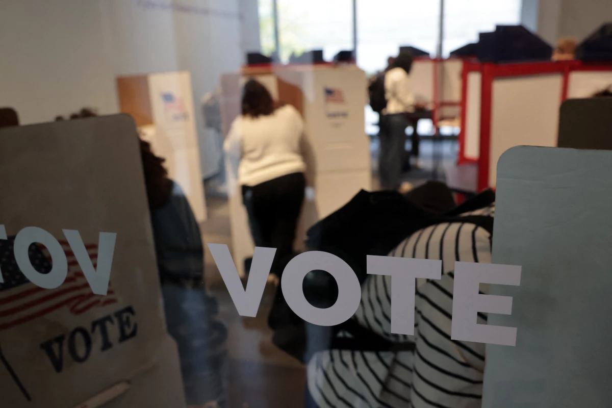 People cast their in-person early ballots for the 2024 general election at a polling station in Ann Arbor, Mich., on Thursday.