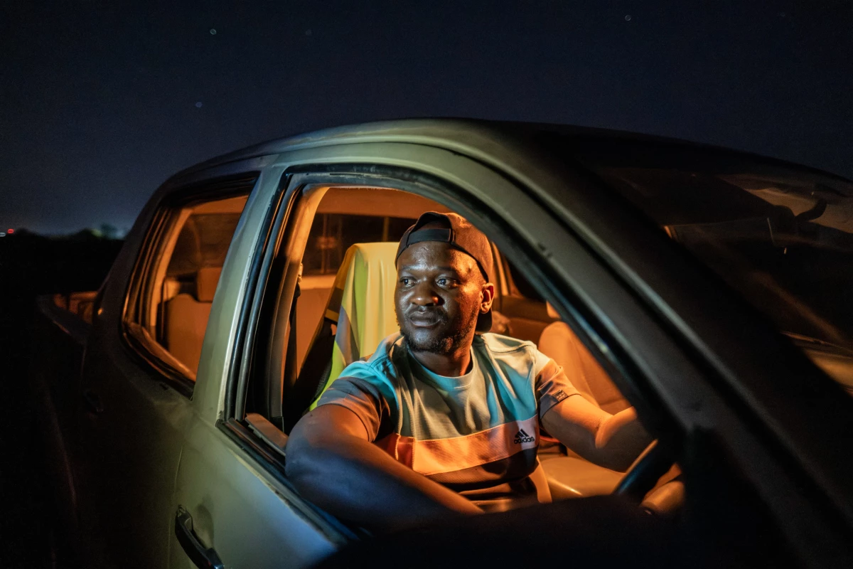 Chamunolwa Jimayi, 29, a driver for the Elephant Response Team, photographed in his vehicle at night in Livingstone, Zambia. 'Sometimes we get more than 30 calls in a day,' says Jimayi, who receives a stipend of around $140 a month.