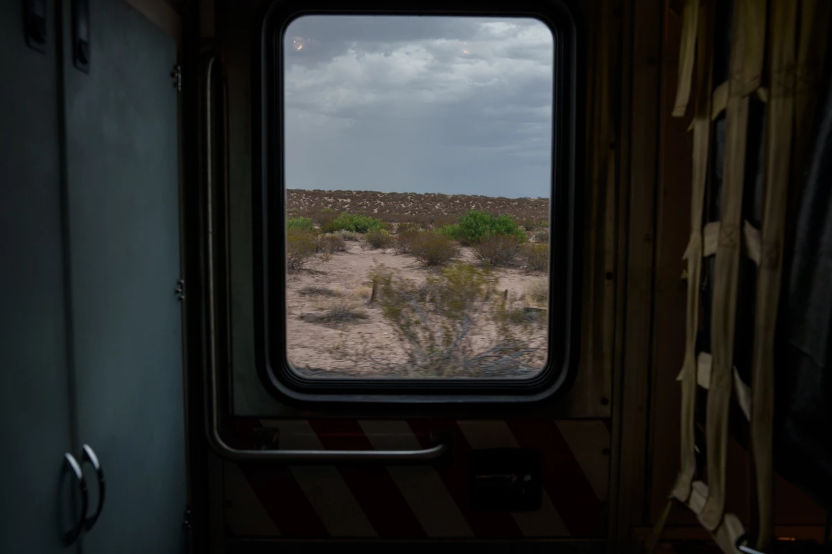 The open desert is seen through the window of a Sunland Park Fire Department ambulance as firefighters respond to a call in Santa Teresa, N.M., on Saturday, June 29, 2024.
