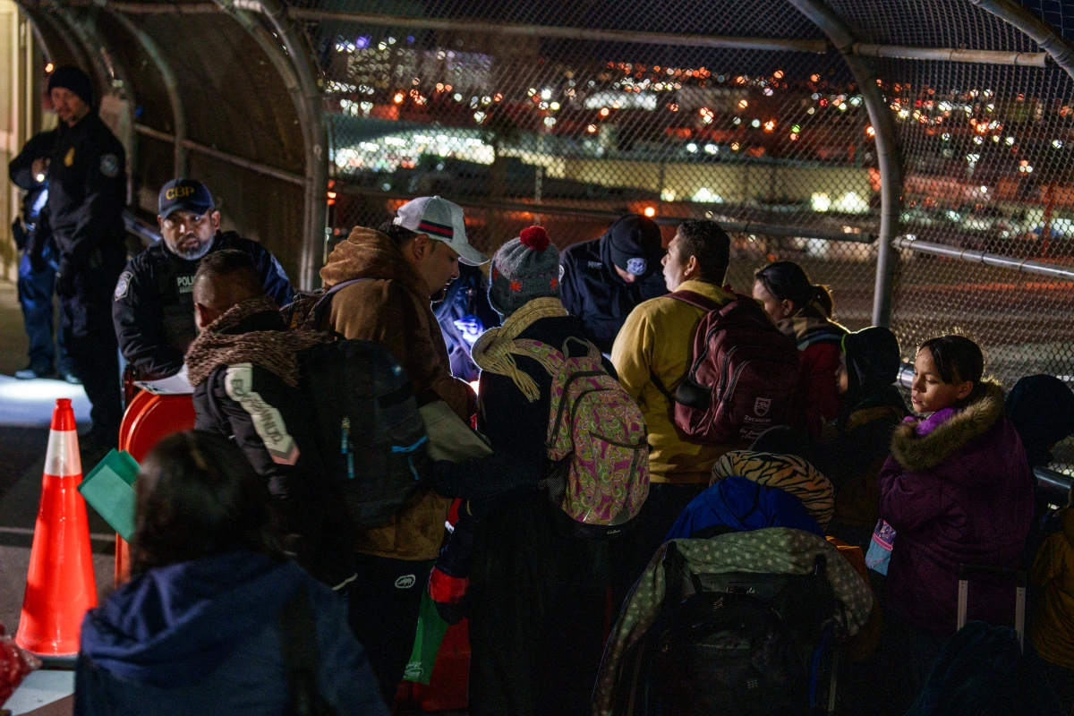 Hondurans David Melgar, 28, his wife Gabriela Maradiaga, 26, and their son Tailer Melgar, 8, have their paperwork checked by CBP agents atop the Paso del Norte Bridge to be allowed into the United States for their CBP One appointment in Ciudad Juárez, Mexico on Monday, December 9, 2024. The family waited only a few weeks to get the appointment in southern Mexico.