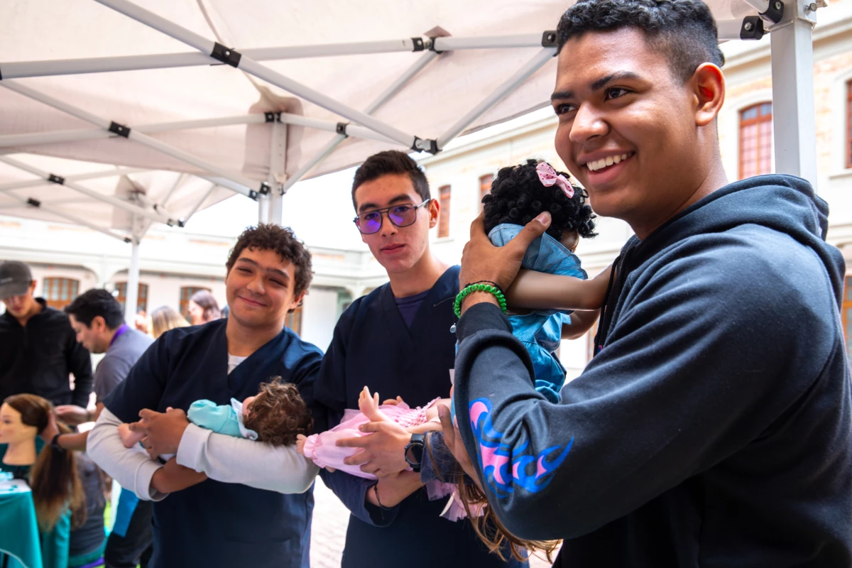 At a one-day workshop run by the Care School for Men in Bogotá, Colombia, male medical students at Sanitas University learn how to cradle a baby. This class of participants consists of medical students, but the usual enrollees are dads of all types.