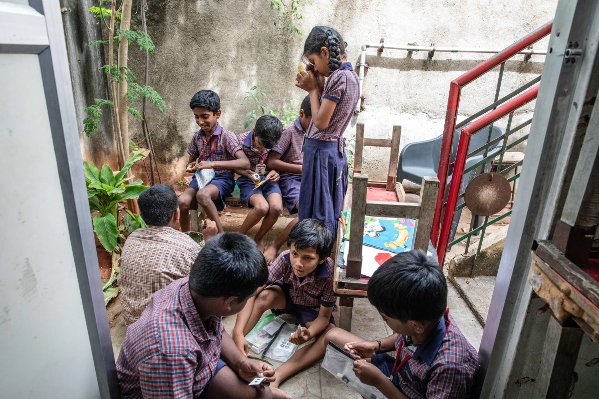 Students at Eden School in northern India prepare specimens they've collected to examine in the Foldscope. The paper microscope, invented a decade ago, is given for free for schools in lower resource countries, giving students a different perspective on specimens from ants to pollen.