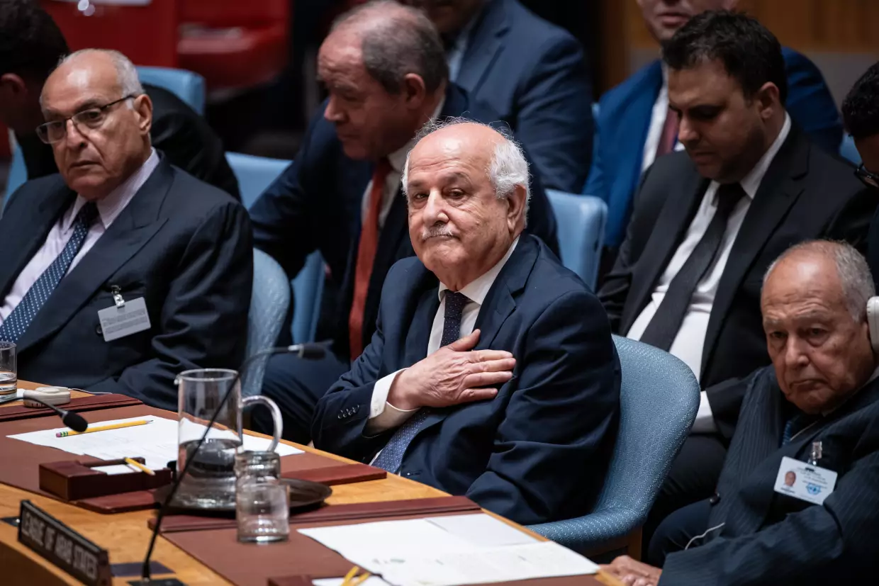 Palestinian Ambassador to the United Nations Riyad Mansour pats his heart during the Kuwait crown prince's address at the High-Level Security Council meeting on Palestinians and Israel during the 80th session of the United Nations General Assembly, Sept. 23, 2025.