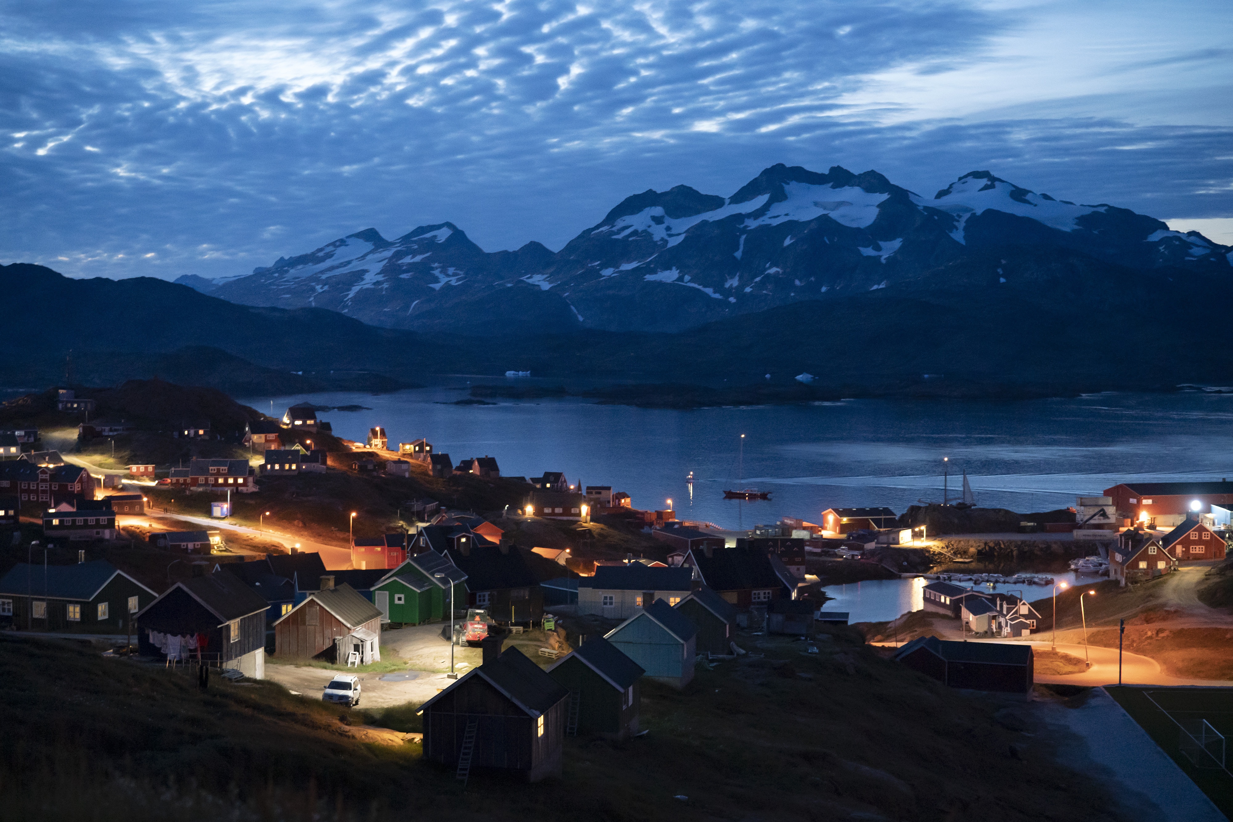 Homes are illuminated after the sunset in Tasiilaq, Greenland, Friday Aug. 16, 2019. (AP)