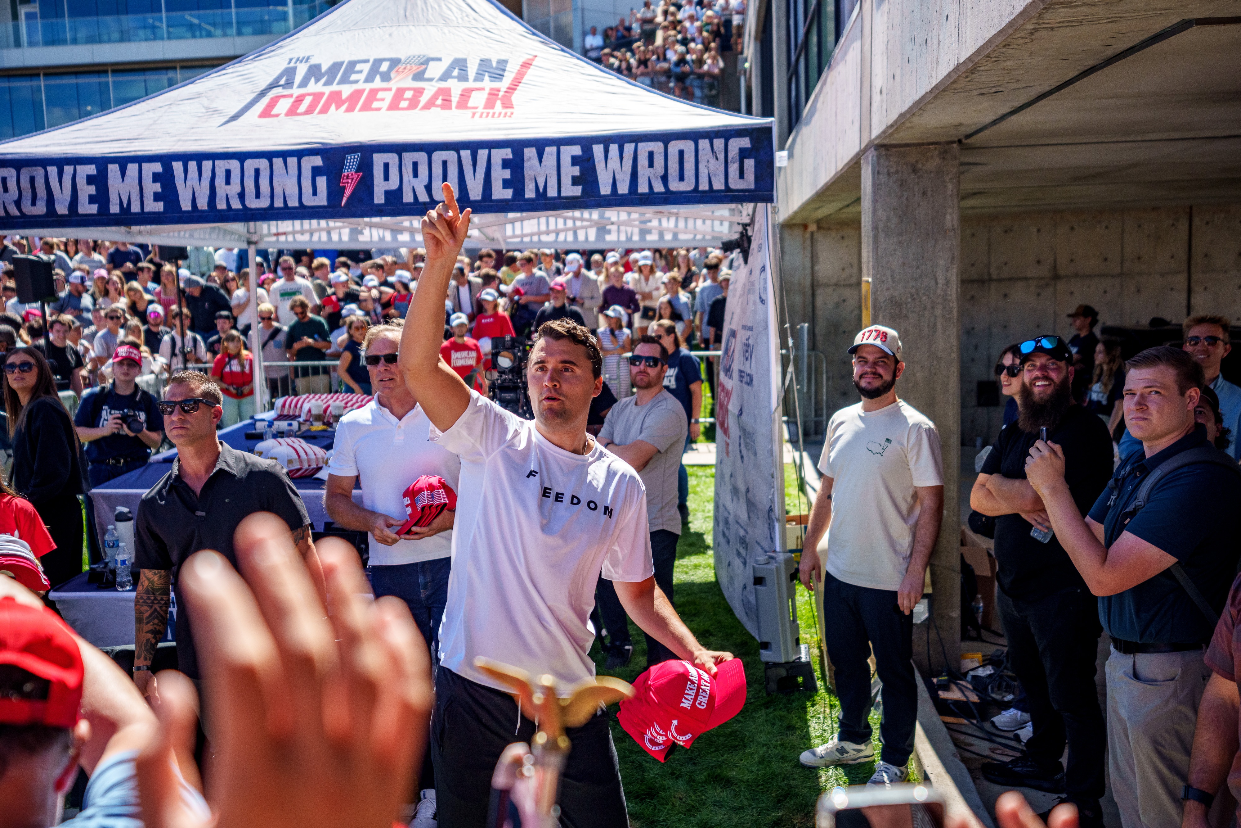 Charlie Kirk throws hats to the crowd after arriving at Utah Valley University on Wednesday for a stop on his "American Comeback Tour." He was fatally shot less than an hour later.