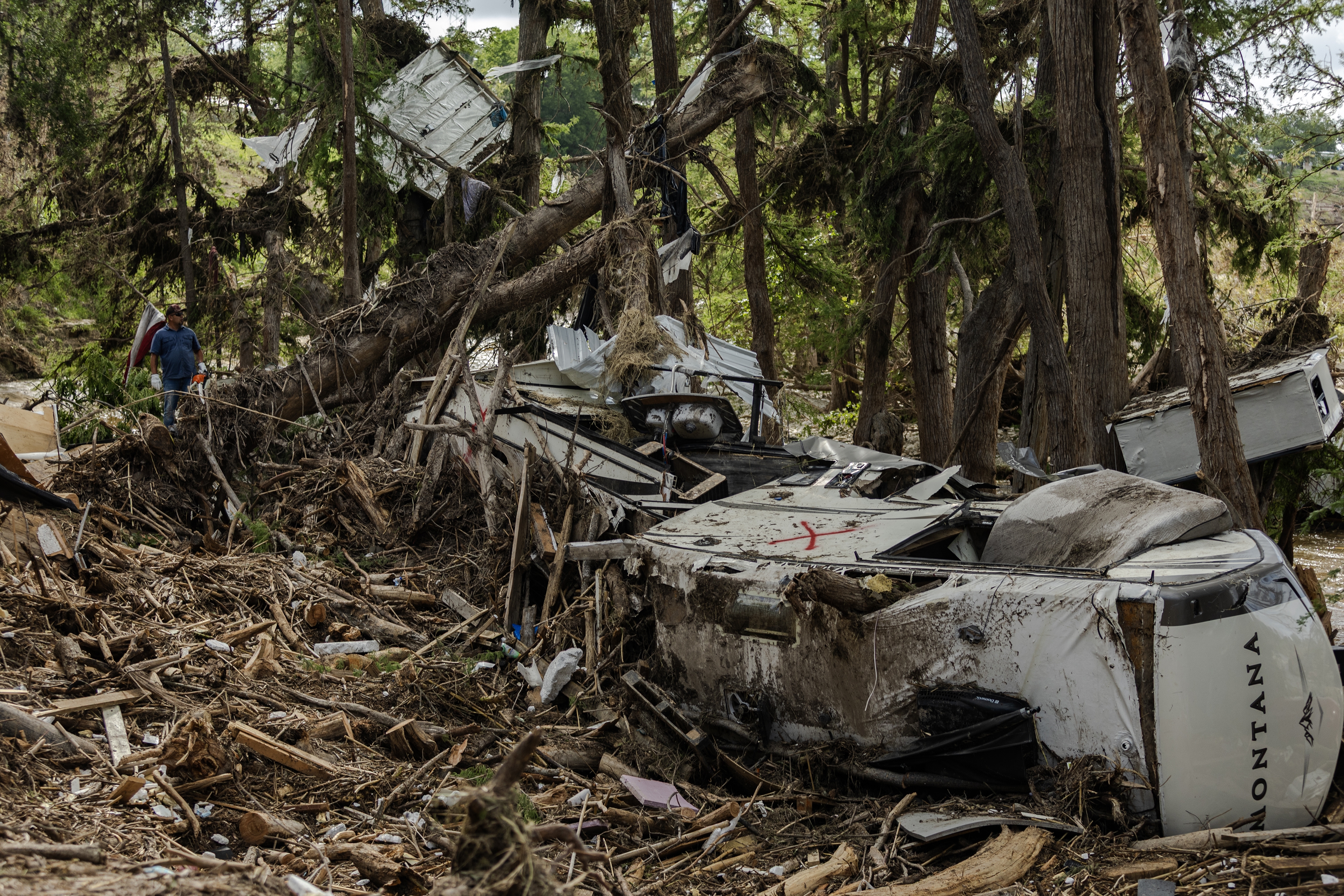 Search and recovery crews remove debris from the bank of the Guadalupe River on July 9, 2025 in Center Point, Texas, after deadly flash floods. Most calls made between July 6th and July 9th to FEMA call centers went unanswered, according to call logs kept by the agency.