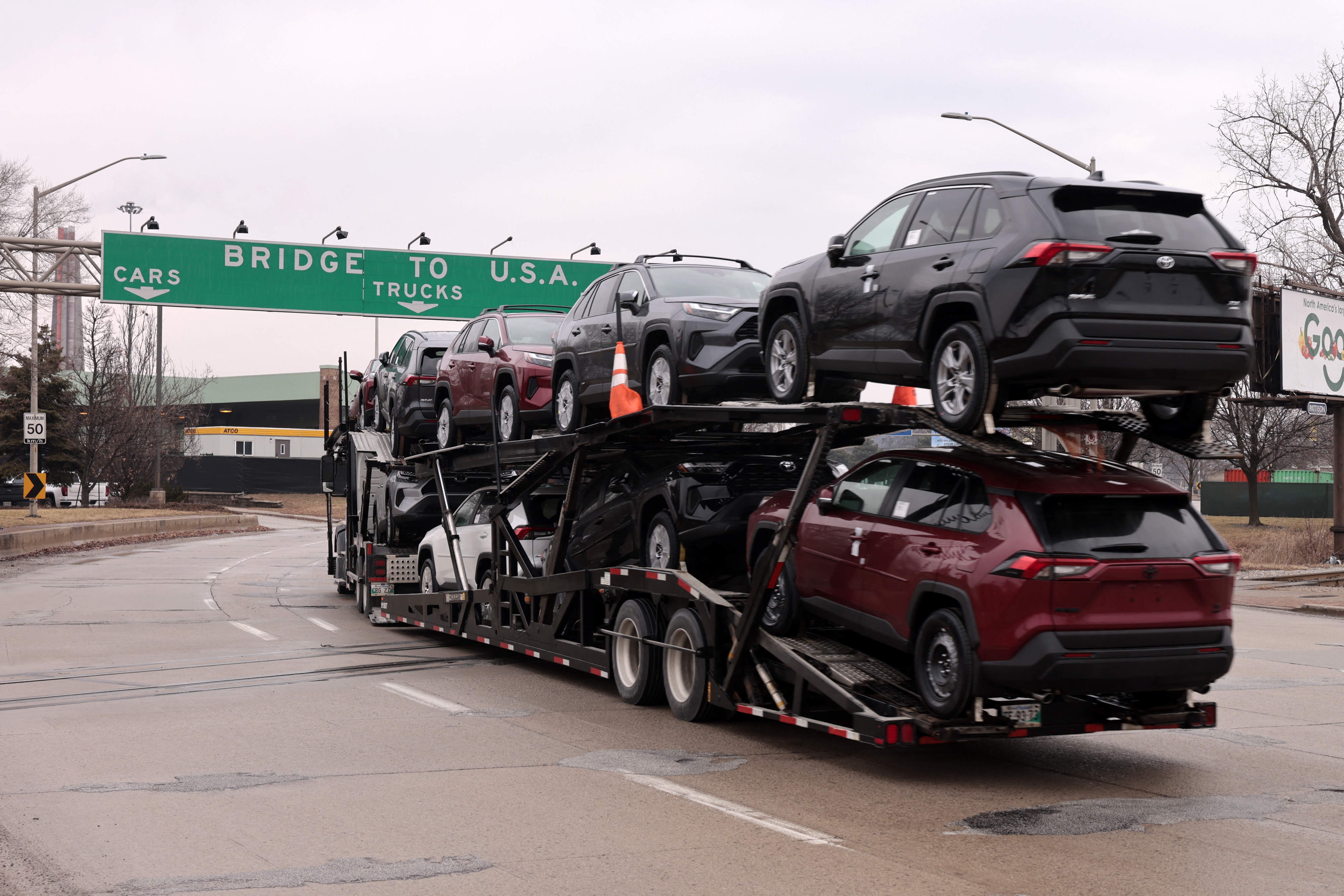 A car hauler carries Toyota RAV4 vehicles as it enters to cross the Ambassador Bridge in Windsor, Ontario to go to Detroit, Michigan on February 3.