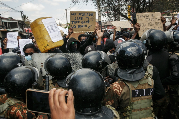 Protesters face security forces during a demonstration against repeated water and electricity outages in Antananarivo on September 27, 2025.