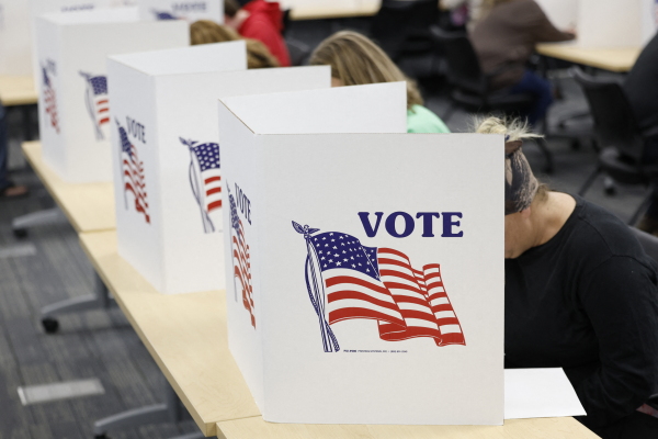 A man casts his ballot during early voting in Waukesha, Wis., on March 18.