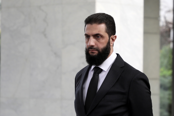 The leader of the new Syrian administration, Ahmed al-Sharaa, waits to meet a Ukrainian delegation on Dec. 30, 2024, in Damascus, Syria.