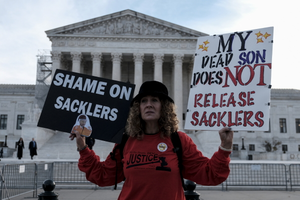 Grace Bisch hold a picture of stepson Eddie Bisch who died as a result of an overdose on outside of the U.S. Supreme Court on December 4, 2023 in Washington, D.C. The Supreme Court overturned a previous version of the Purdue Pharma-Sackler bankruptcy plan, leading to a new deal now under review.