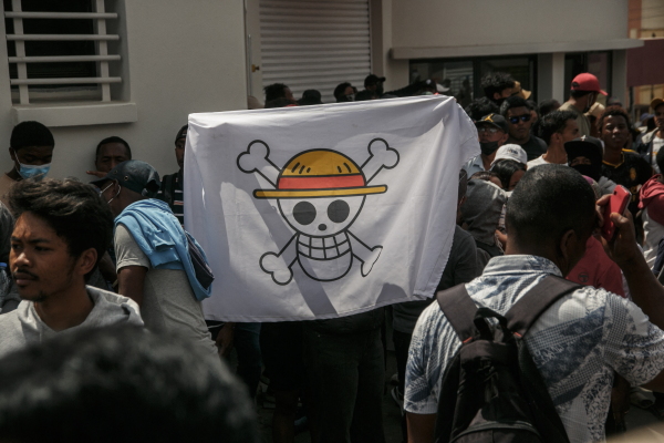 A protester holds a pirate flag from the Japanese anime One Piece during a demonstration against repeated water and electricity outages in Madagascar. Inspired by "Gen Z" protests in Indonesia and Nepal, the youth-led movement has taken aim at corruption