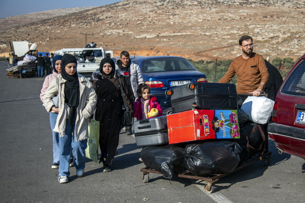 Syrians who have been refugees in Turkey arrive at the Turkey-Syria border crossing near the Turkish town of Antakya as they return to their homeland. Some 3 million Syrians have been living in Turkey.
