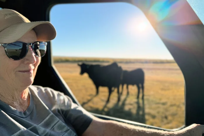 Katie Baltzor rides her side-by-side among the black angus cattle she raises near her home outside of Hines, Oregon.