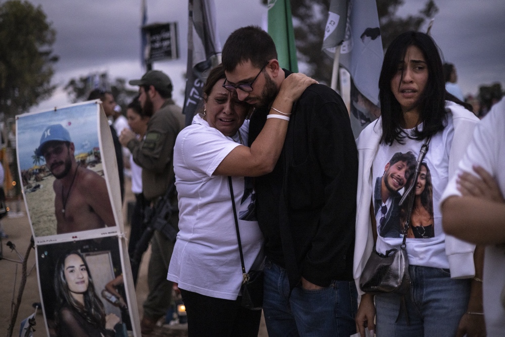 Two people embrace as relatives and supporters of Israelis killed in the Oct. 7, 2023 Hamas attack attend a ceremony at the Nova memorial near Kibbutz Reim in southern Israel on Oct. 7, 2024. (AFP via Getty Images)