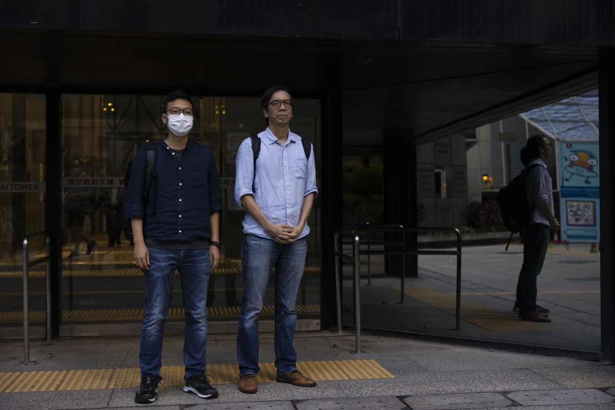 Former chief editor Chung Pui-kuen, right, and former acting editor Patrick Lam, left, of the now-defunct independent media outlet Stand News leave the court on the last day of the publication's sedition trial closing statements in Hong Kong on June 28, 2023.
