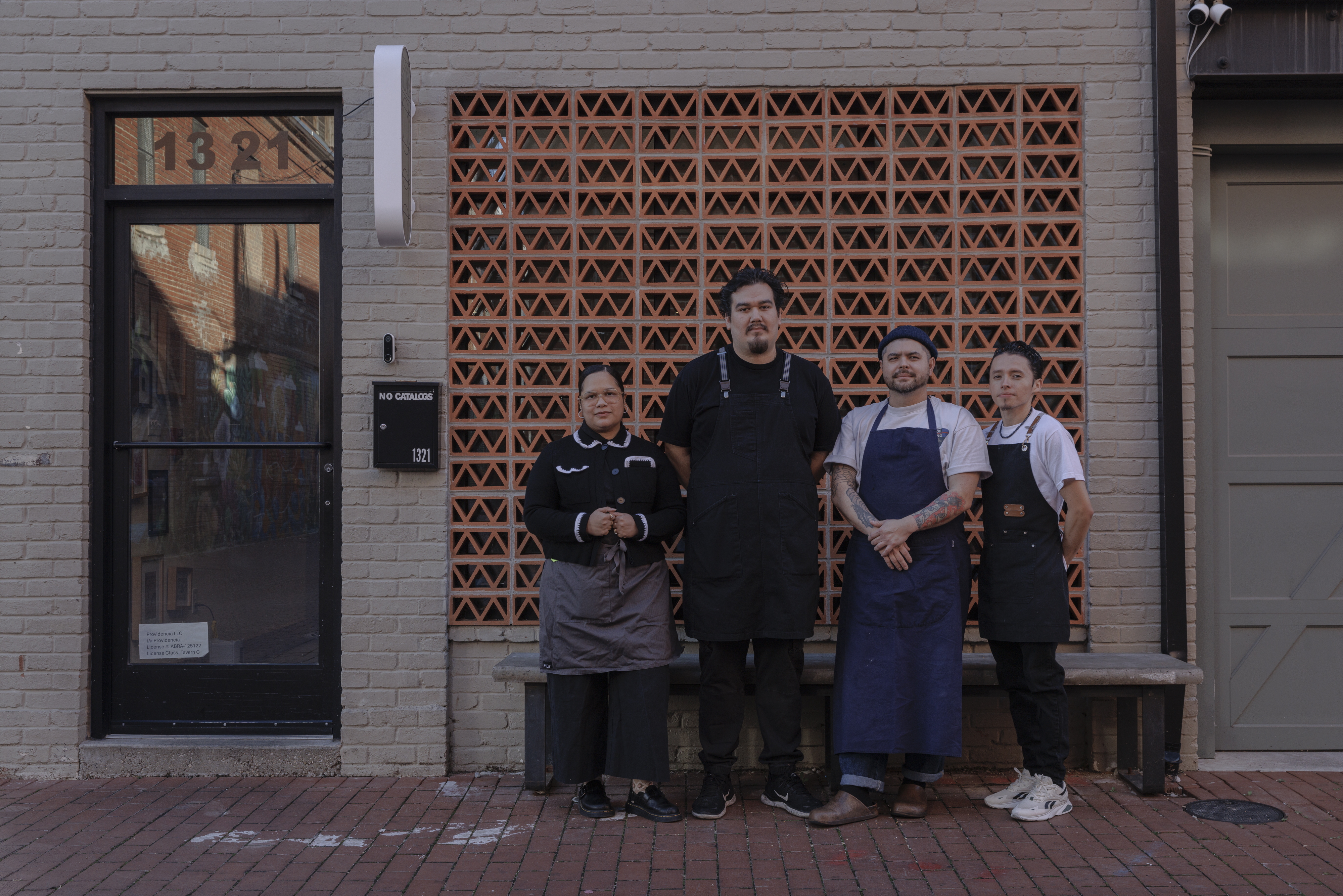 From left to right, Paola Velez, Pedro Tobar, Erik Bruner-Yang and Daniel Gonzalez pose for a photo outside the newly opened alley bar Providencia in Washington, D.C., on Dec. 12.