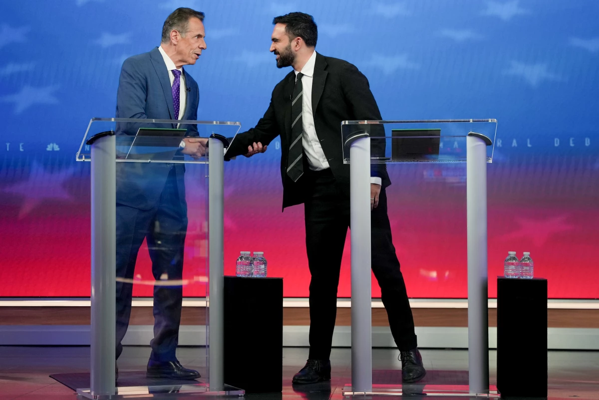 Andrew Cuomo, New York City mayoral candidate, left, and Zohran Mamdani, New York City mayoral candidate, shake hands during a mayoral debate in New York Thursday, Oct. 16, 2025.