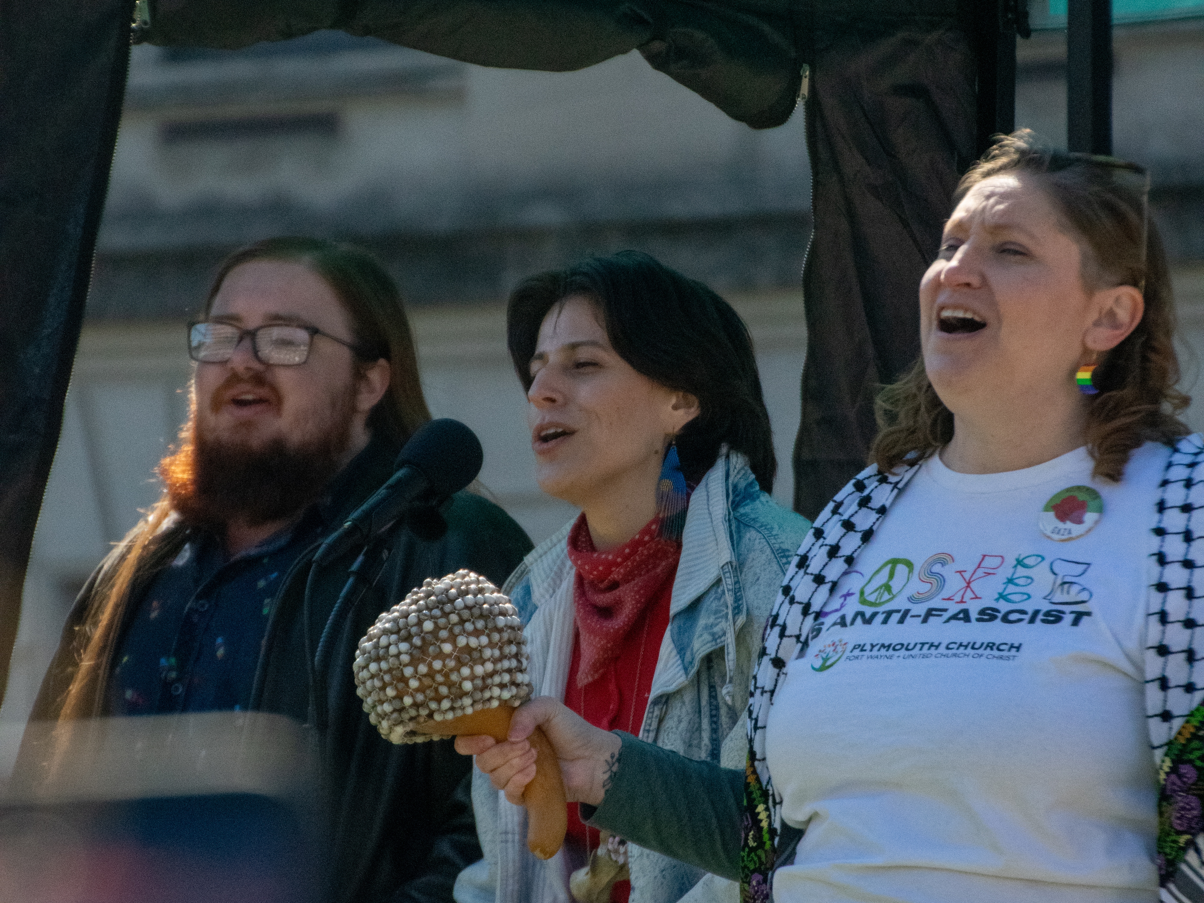 Sara Offner-Seals is joined on stage by two members from Fort Waynes singing resistance group as they lead the crowd in a protest song on Saturday. Offner-Seals says singing resistance groups have been cropping up across the country and offer people connection and a bit of joy to avoid protest burnout.